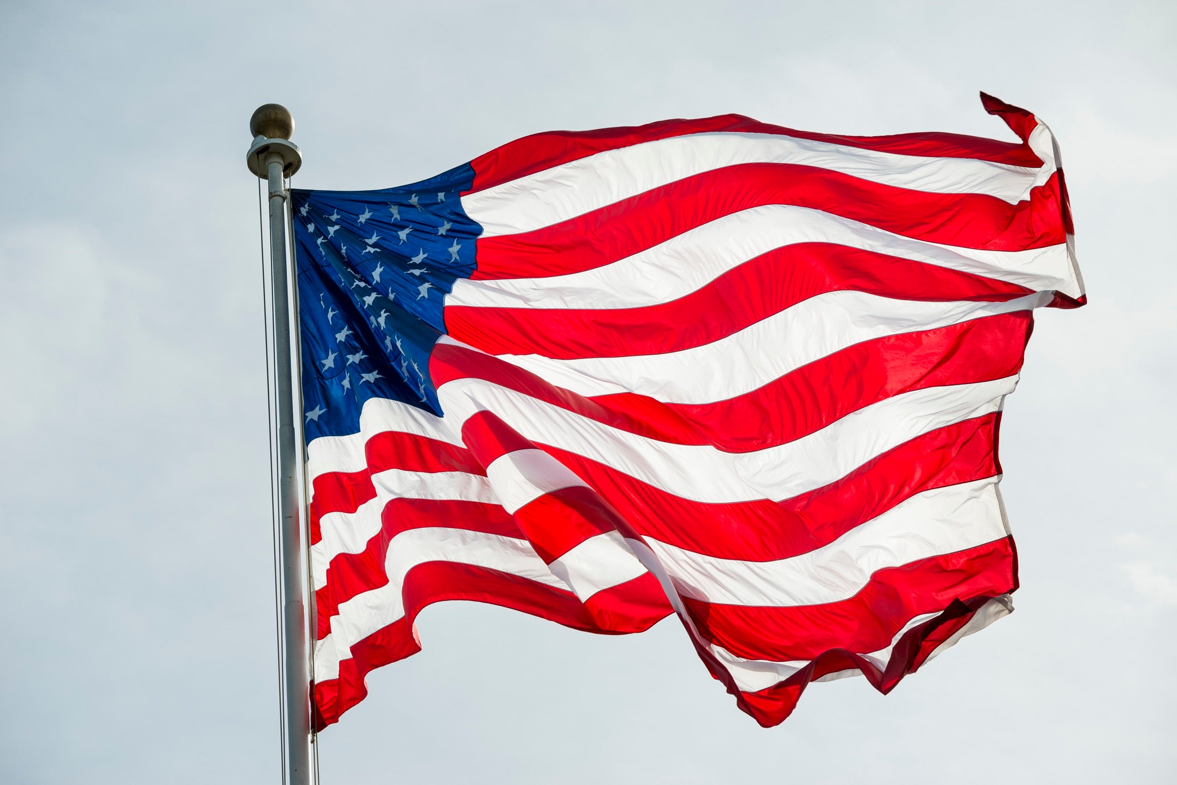 The American flag waving against the sky